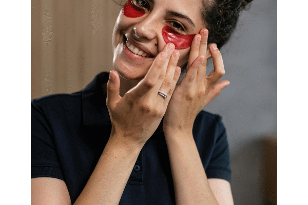 Woman gently treating puffy eyes with skincare routine for better eye health
